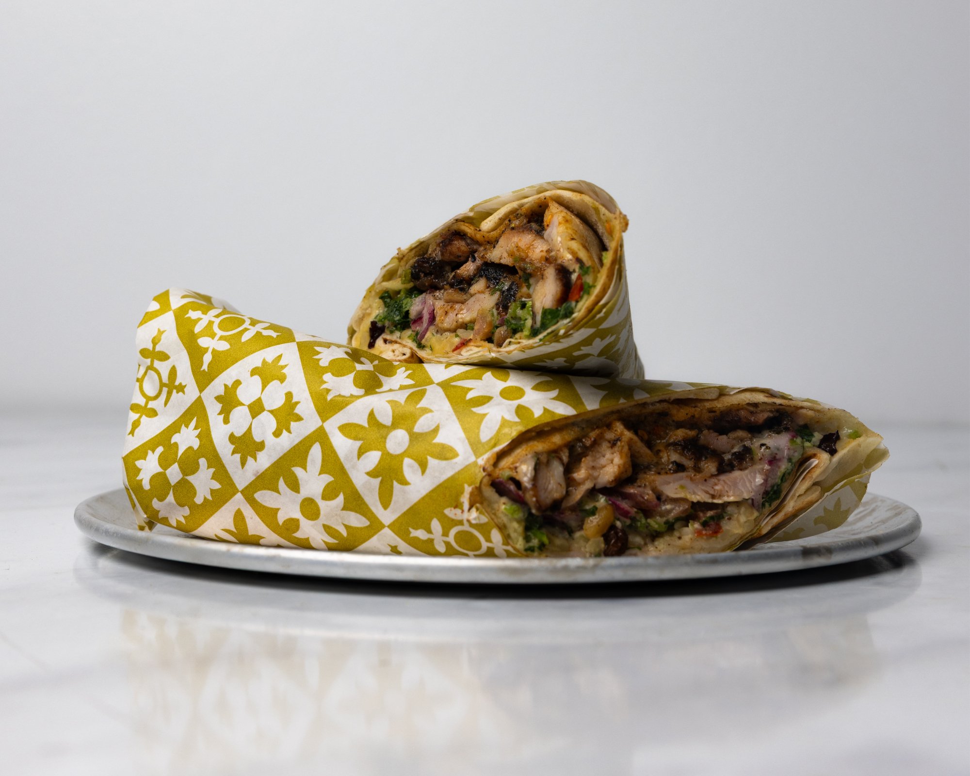 Shawarma Chicken with hummus, toum, tabouli, jeweled salad.