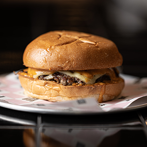 Smashed cheeseburger and chips.